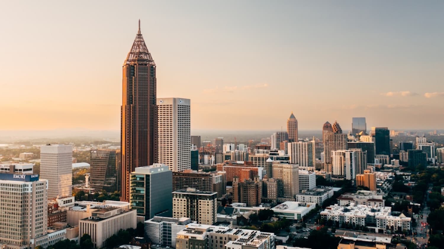 Bank of America Plaza's spire above downtown Atlanta at dusk, with the Midtown skyline beyond